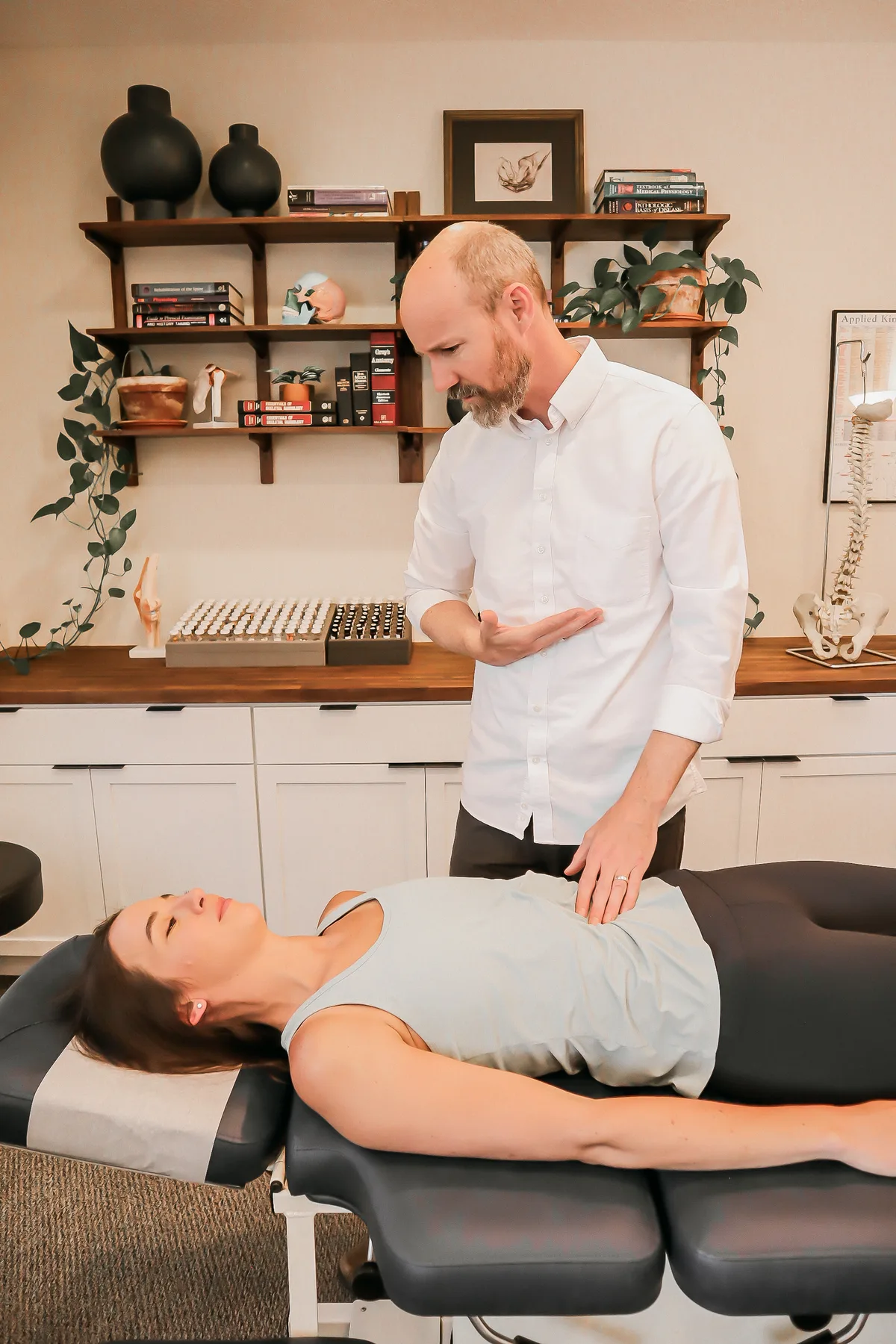 Dr. Andrew Rostenberg in a one-on-one consultation with a patient at his desk at Red Mountain Natural Medicine in Boise, Idaho